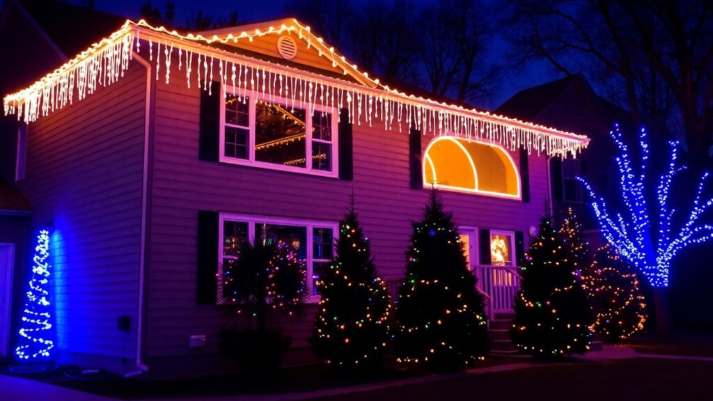House decorated with colorful Christmas lights at dusk.